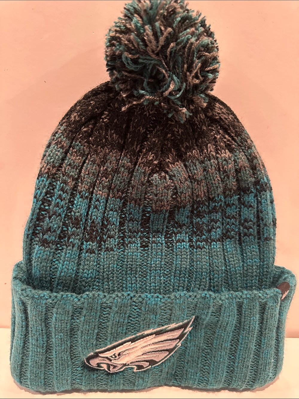 NWT NFL Philadelphia Eagles Pacific Green Beanie with Pompom and Eagle insignia.